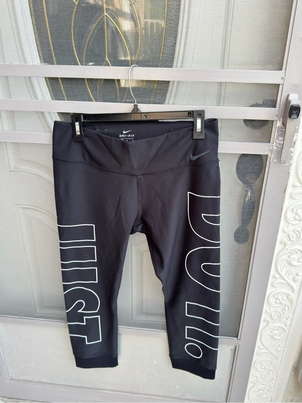Nike Black Cropped Dri-FIT Leggings with White 'JUST DO IT' Side Graphics